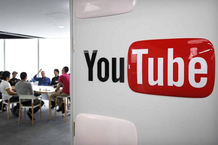 Google Inc.'s YouTube logo is displayed on a wall as video creators participate in a workshop as part of the YouTube Partner Program at the company's YouTube Space studio in Tokyo, Japan, on Saturday, March 30, 2013. In Japan, YouTube's biggest regional success story in Asia, the company is recruiting online stars to bolster its local-language channels with more-targeted original programming and higher production values. Photographer: Kiyoshi Ota/Bloomberg via Getty Images