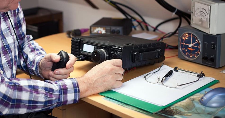 Enthusiastic middle-aged radio-amateur at his station